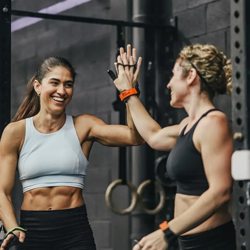 a photo of two happy woman doing a high five