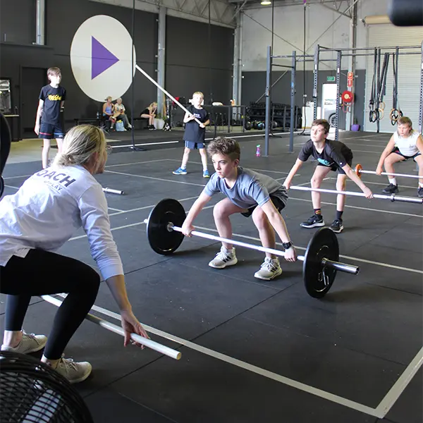 a kid preparing for a weight lifting exercise